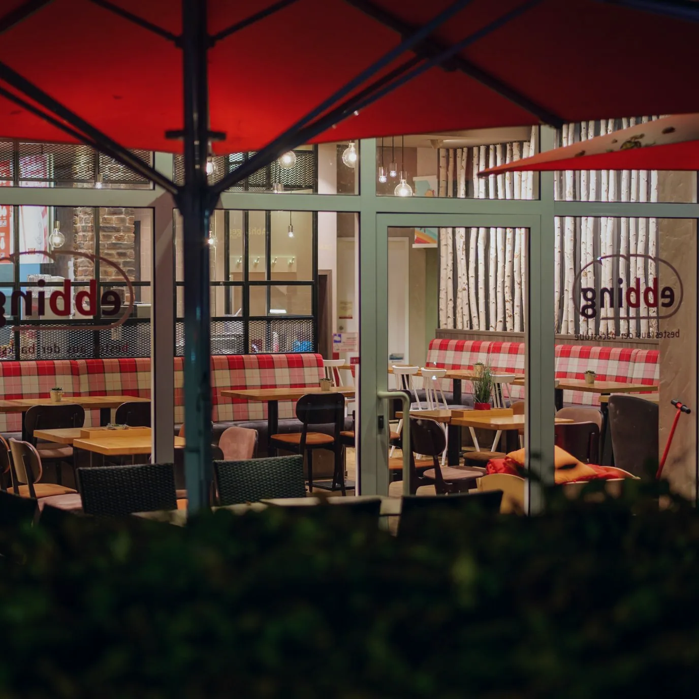 The card room at Southern Quay, six tables set beneath tall windows facing the reserve
